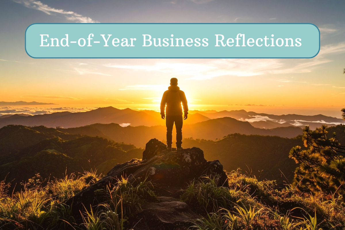 man standing on rock looking out on mountain range